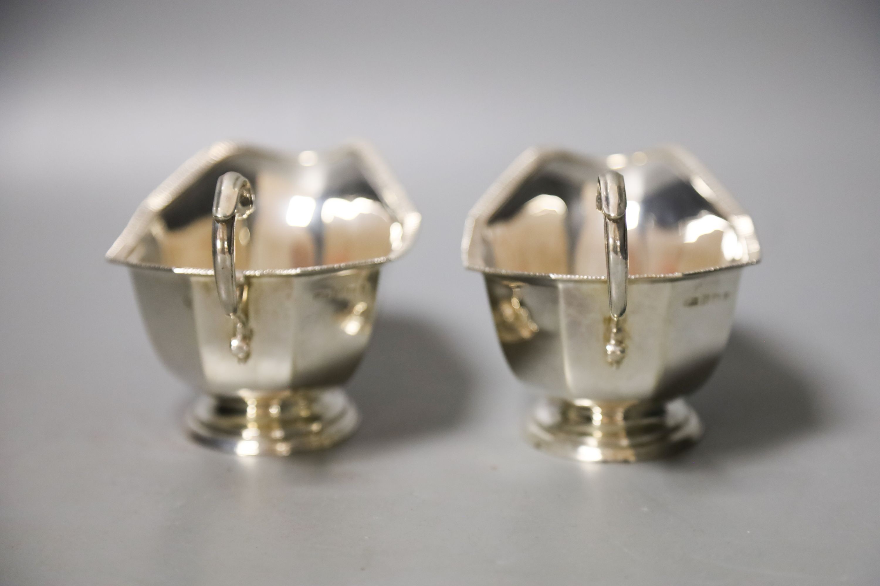 A pair of 1930's silver sauceboats, with flying scroll handles, 16.2cm, 8oz.